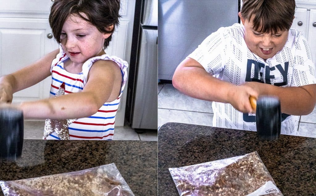 Girl and Boy Smashing Pretzels with a Mallet.