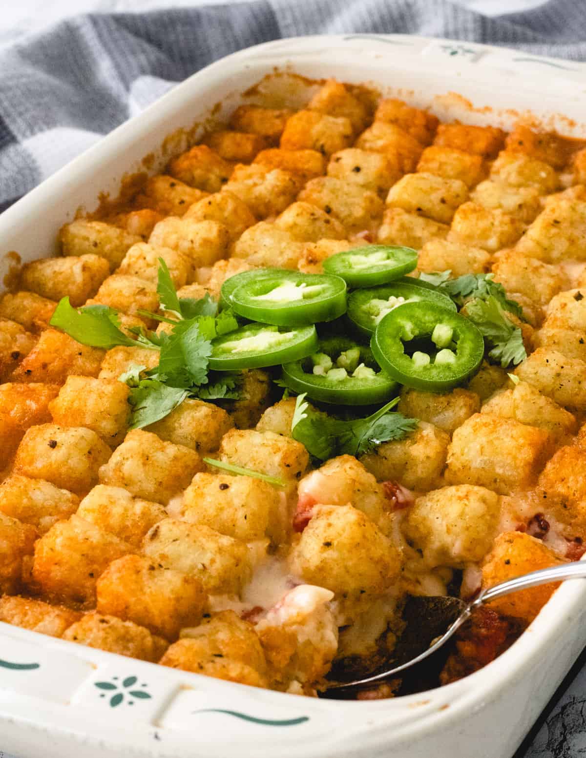 Tater tot casserole with a scoop missing.