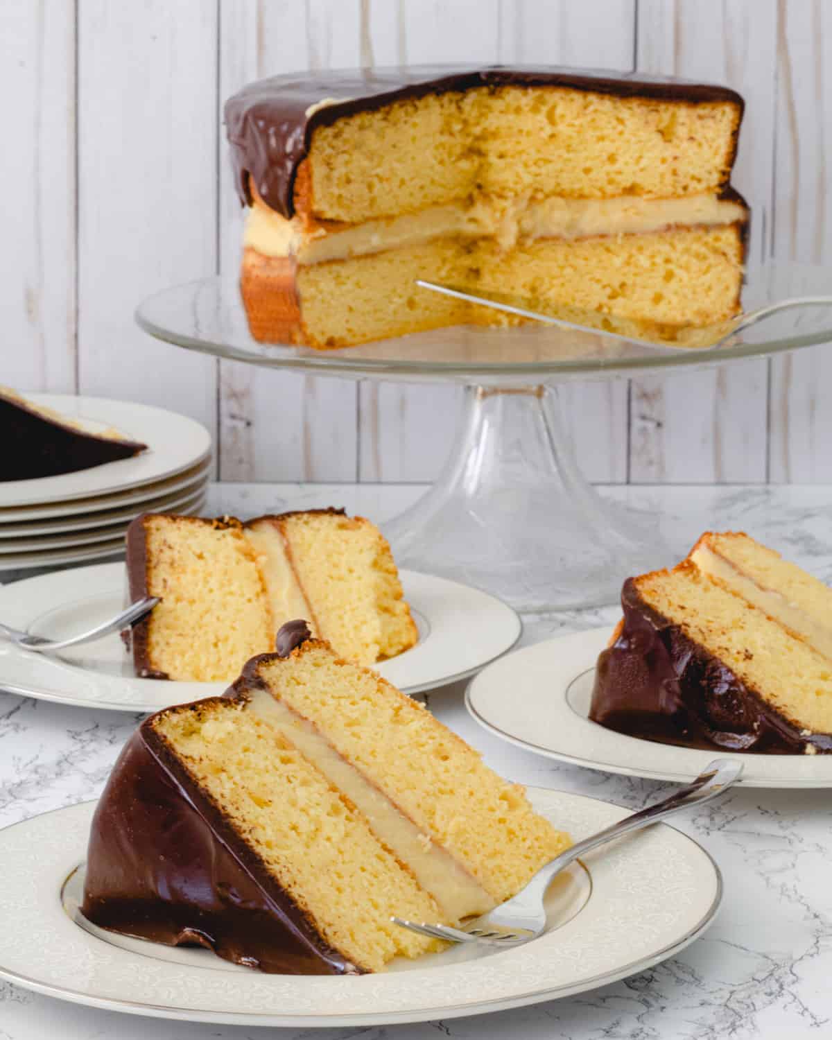 Slices of cakes on plates, with remaining cake on a cake plate.