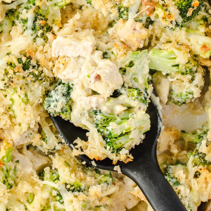 broccoli & chicken casserole scooped with a black spoon.