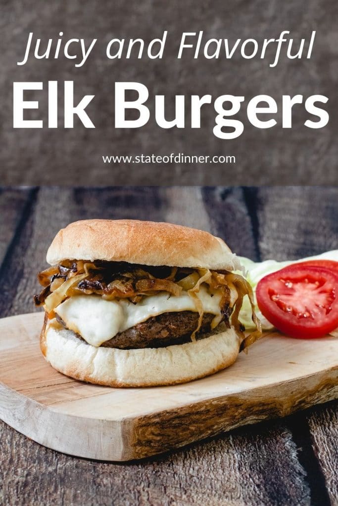 Pinterest Pin: Juicy and flavorful elk burgers - elk burger on a board with tomato and lettuce.