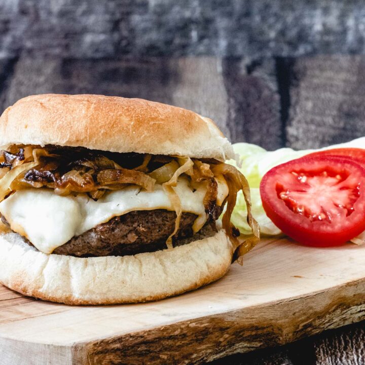 elk burger with cheese and caramelized onions.