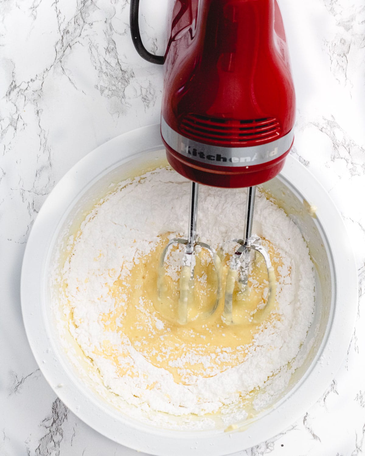 Blending the filling with a red Kitchen Aid hand mixer.