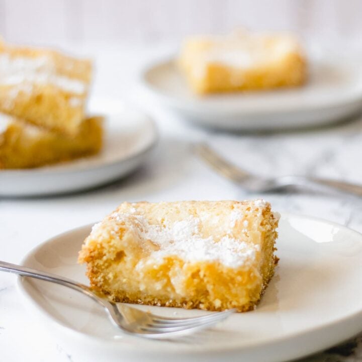 Slices of gooey butter cake on plates.