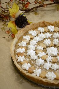 Maple tart with stars of whipped cream over top.
