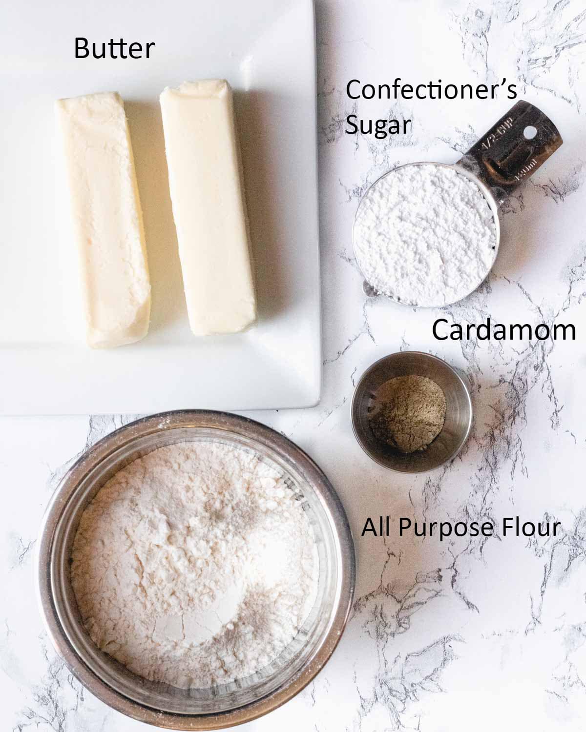 Cardamom shortbread cookie ingredients: butter, confectioner's sugar, flour, and cardamom.