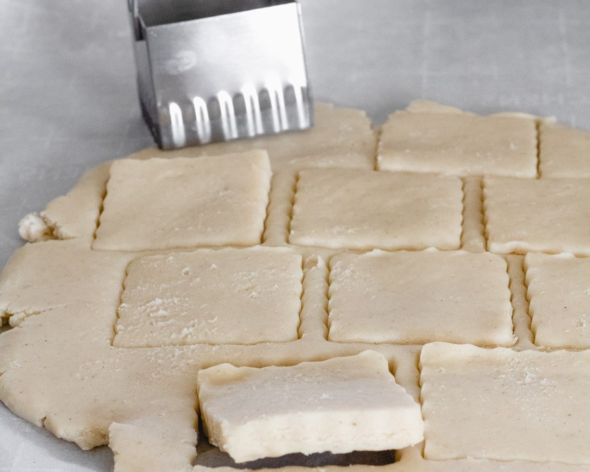 Cut outs of dough using scalloped square cutter.