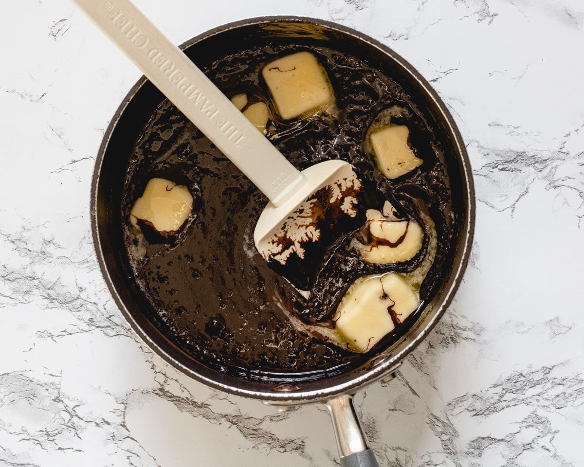 Melted chocolate and chunks of butter in a saucepan.