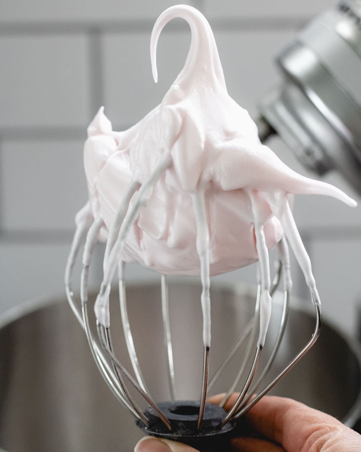 Stiff peak egg whites on a wire whisk.