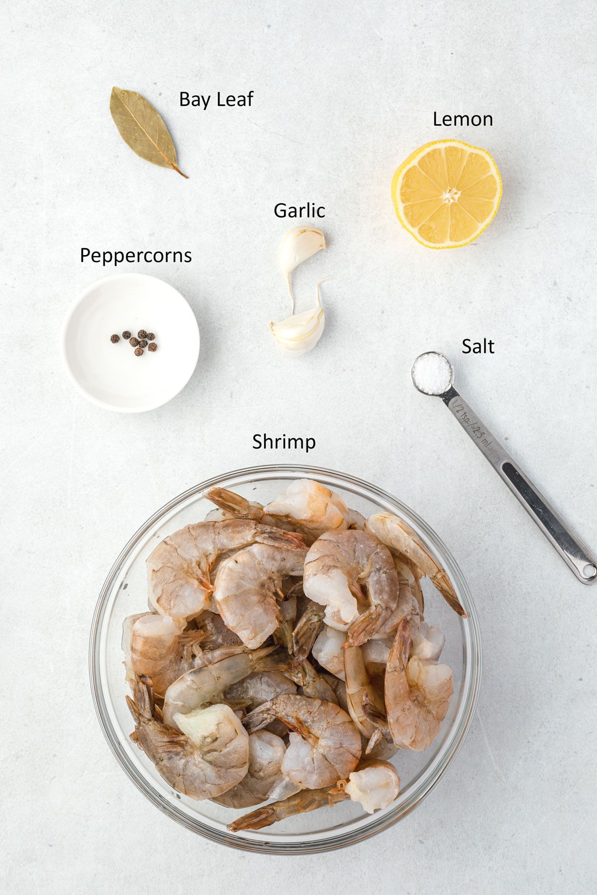 Overhead of labelend ingredients for poached shrimp.