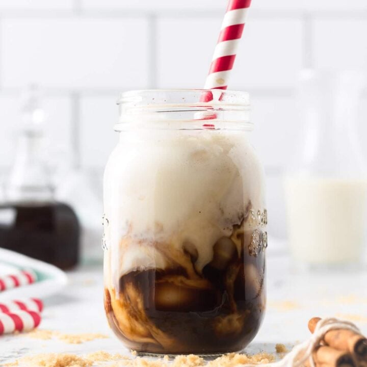 Brown sugar shaken espresso in a mason glass with a red and white striped straw.
