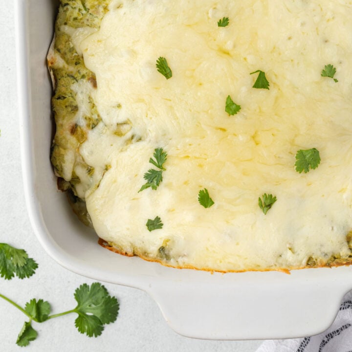 Close up of cheesy baked New Mexico green chile enchiladas.