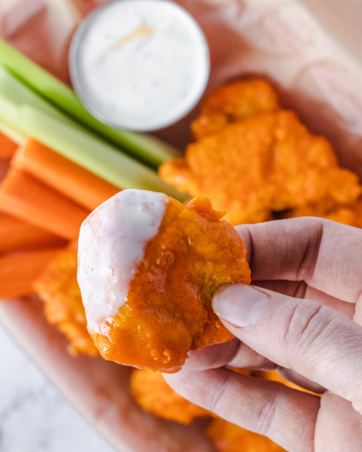A boneless wing dipped in ranch dressing.