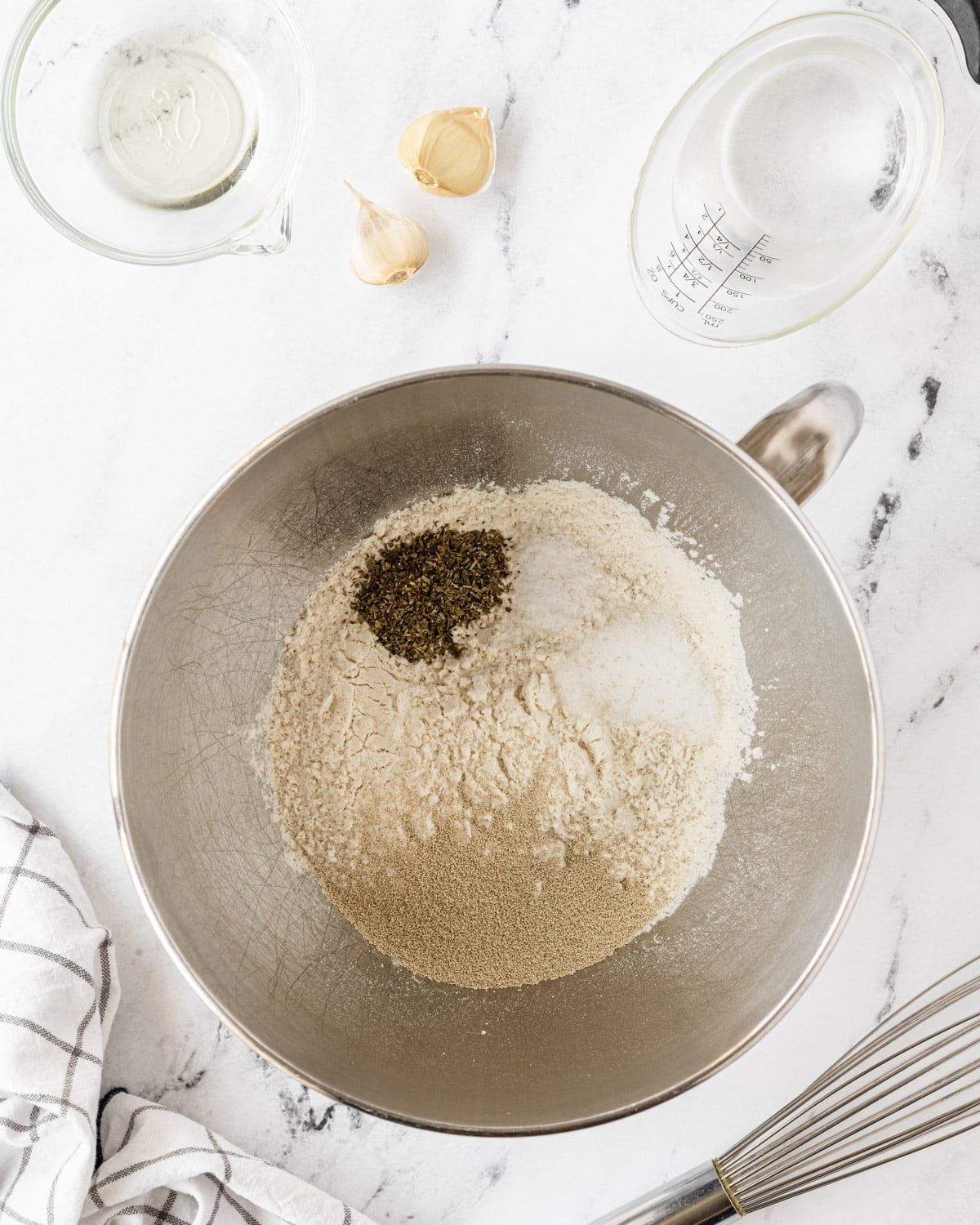 Pizza crust dry ingredients in a large mixing bowl.