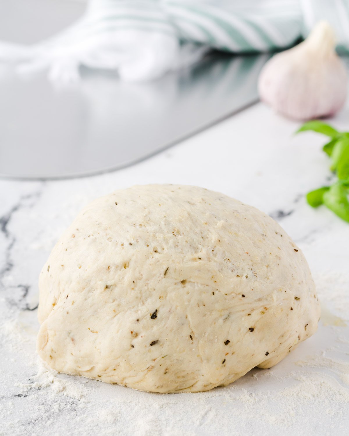 Ball of garlic and herb pizza dough.