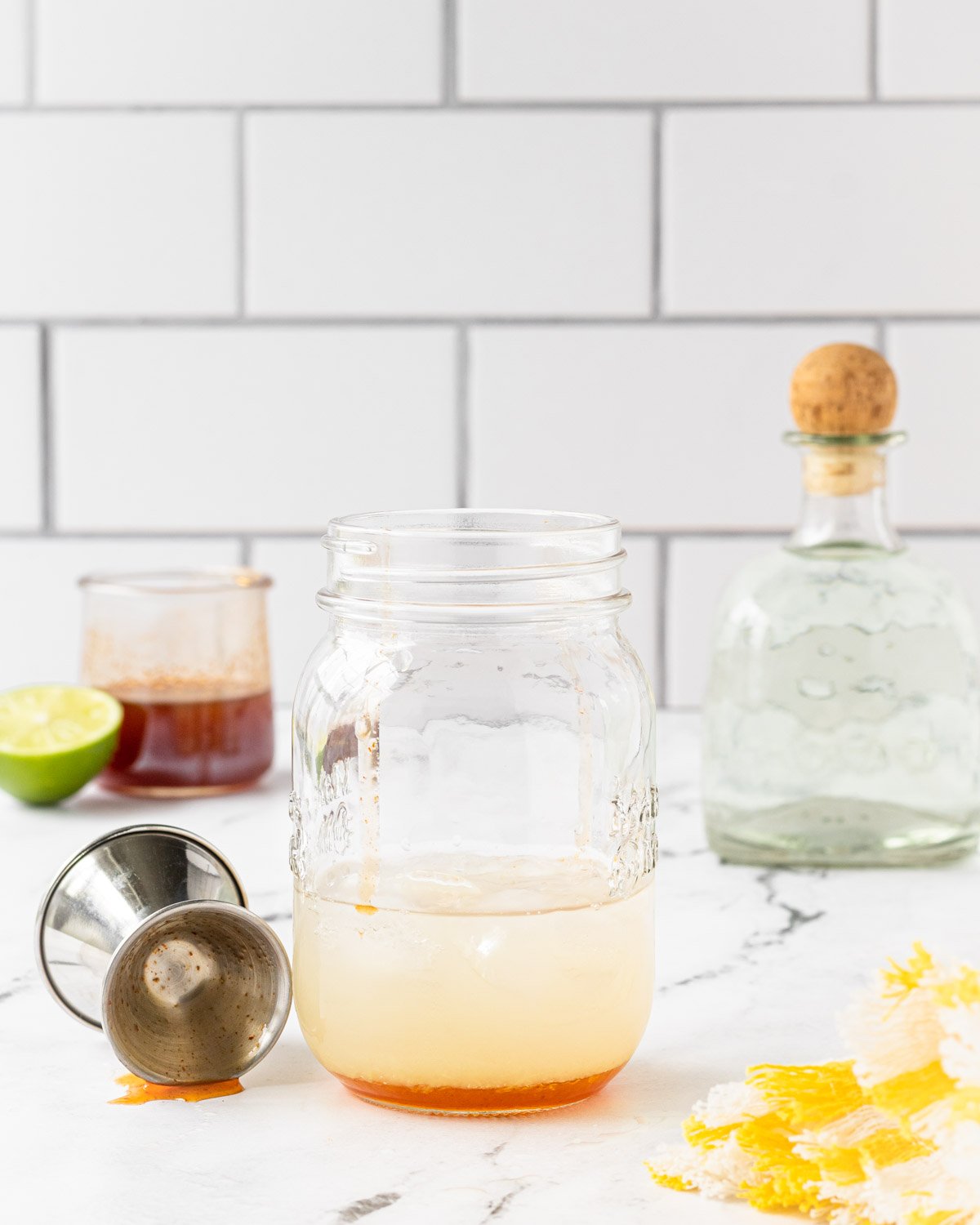 Hot honey added to mason jar with other ingredients.
