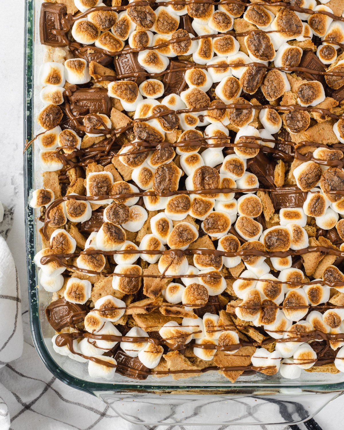Close up of the pan, showing toasted marshmallows on top of the bars.