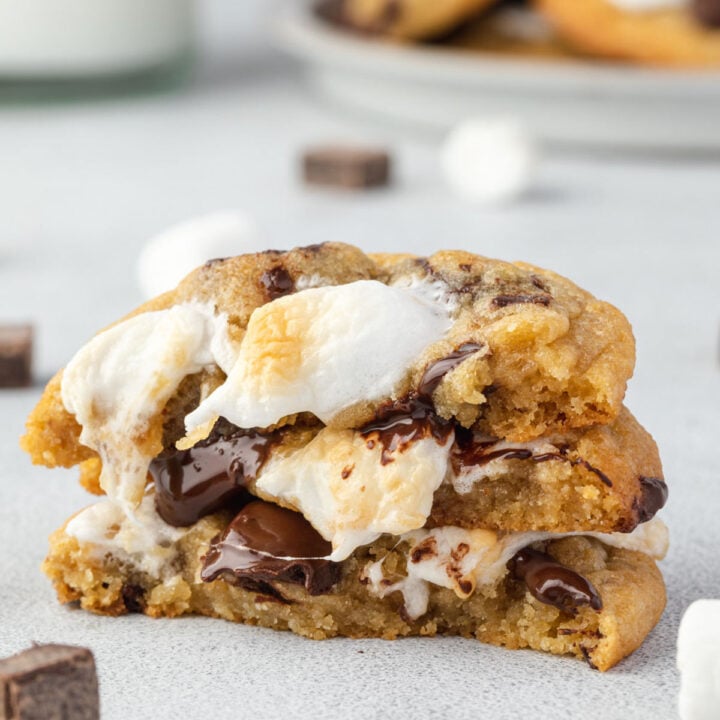 Stack of 3 cookie halves with marshmallow and chocolate oozing down the stack.