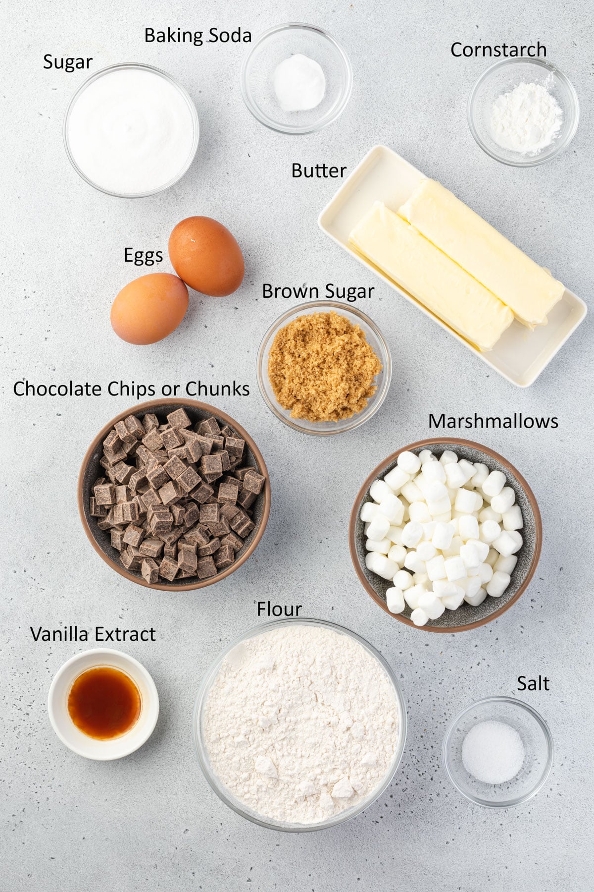 Overhead of labeled marshmallow chocolate chip cookie ingredients.