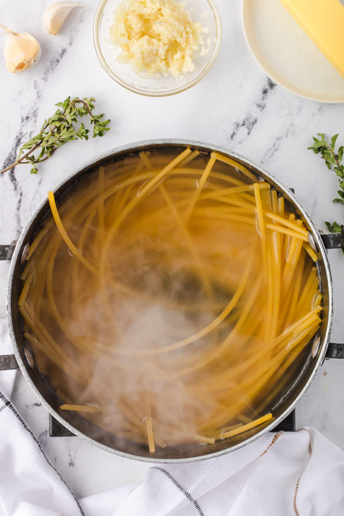 Pasta in water wtih steam rising up.