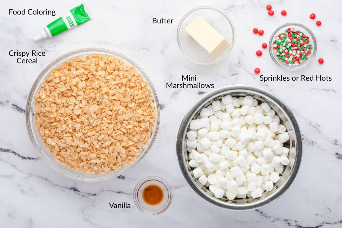 Bowls of crispy rice cereal, mini marshmallows, butter, vanilla, sprinkles, and a tube of green food coloring.