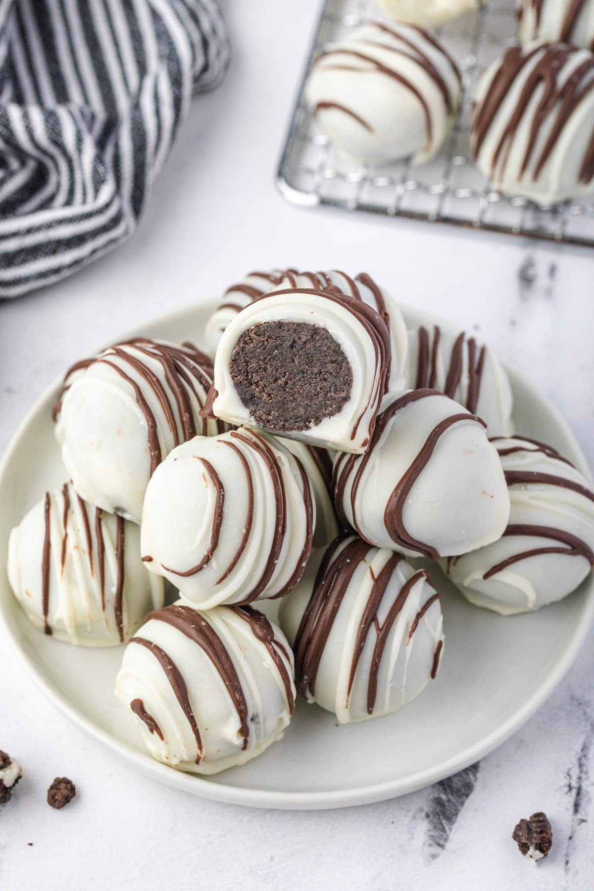 Plate of oreo truffles with one sliced open.