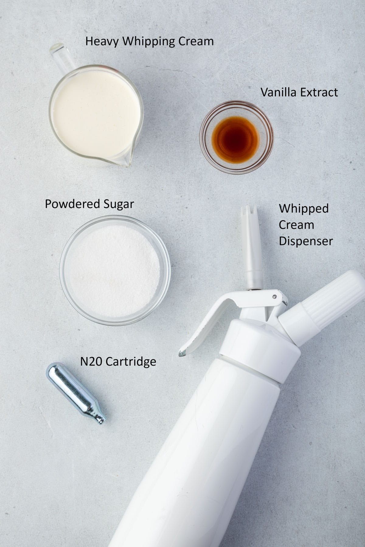 Ingredients and equipment needed for whipped cream dispenser recipe.