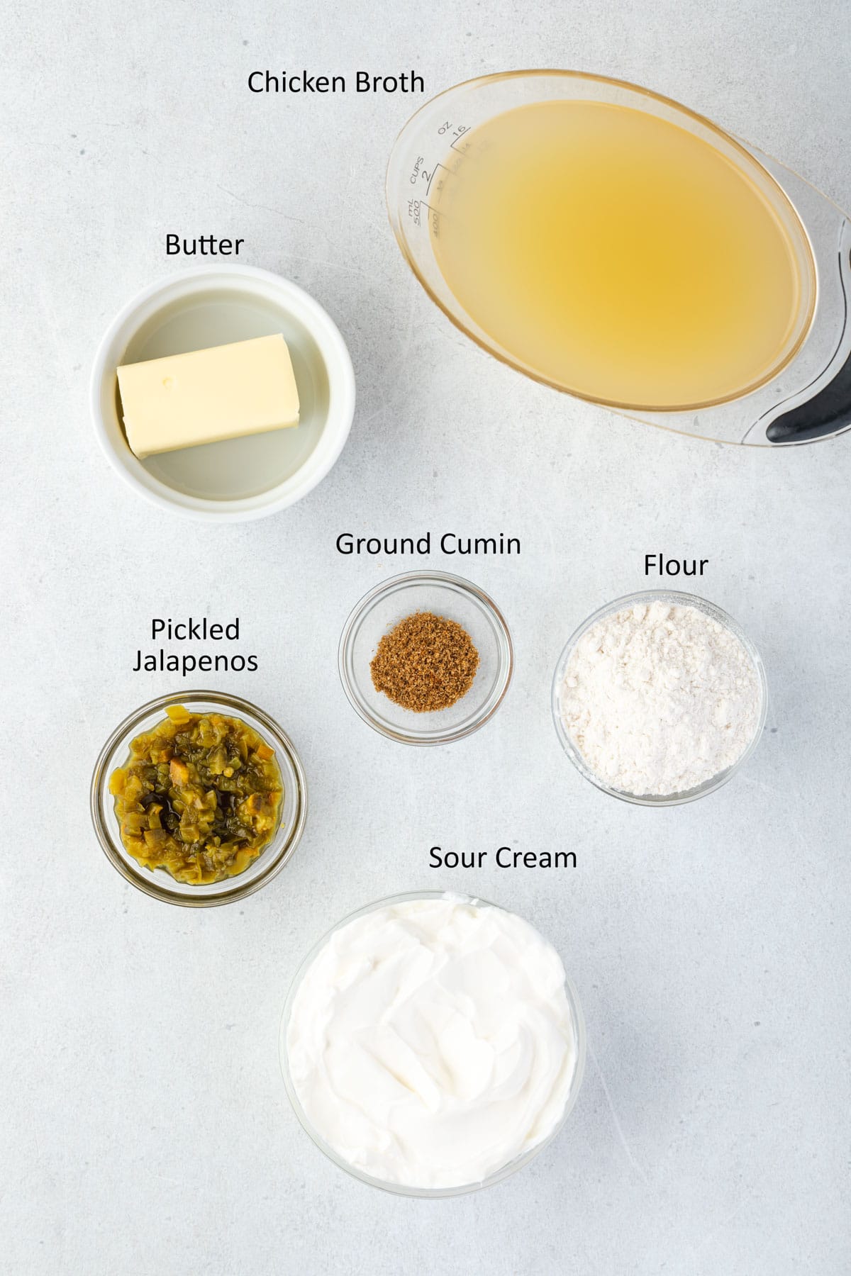 Overhead of labeled sour cream sauce ingredients.