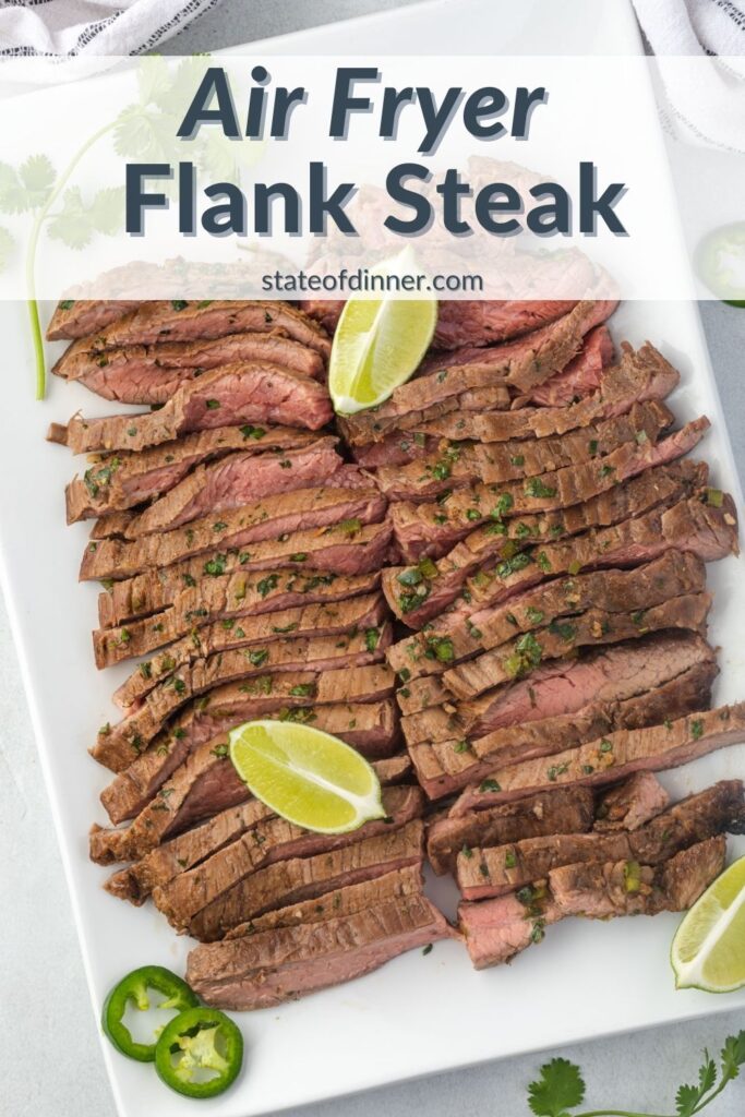 Pinterest Pin: Air Fryer flank steak sliced on a white rectangular platter with lime wedges and sliced jalapeno on top.