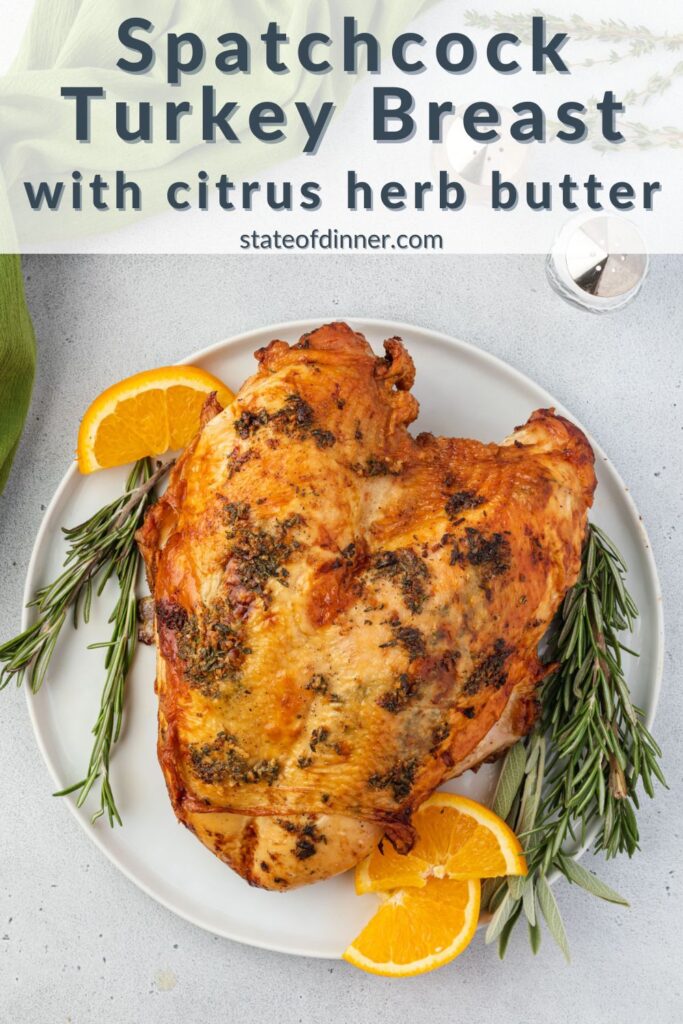 Pinterest pin: Roasted turkey breast with herb butter on a plate with rosemary and oranges.
