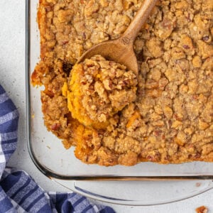 Overhead of sweet potato crunch with a spoon of casserole resting on the dish.