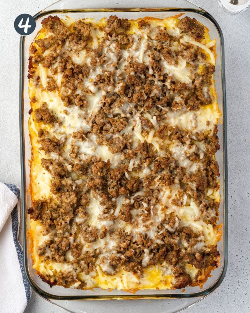 Overhead of egg casserole with sausage crumbles on top.