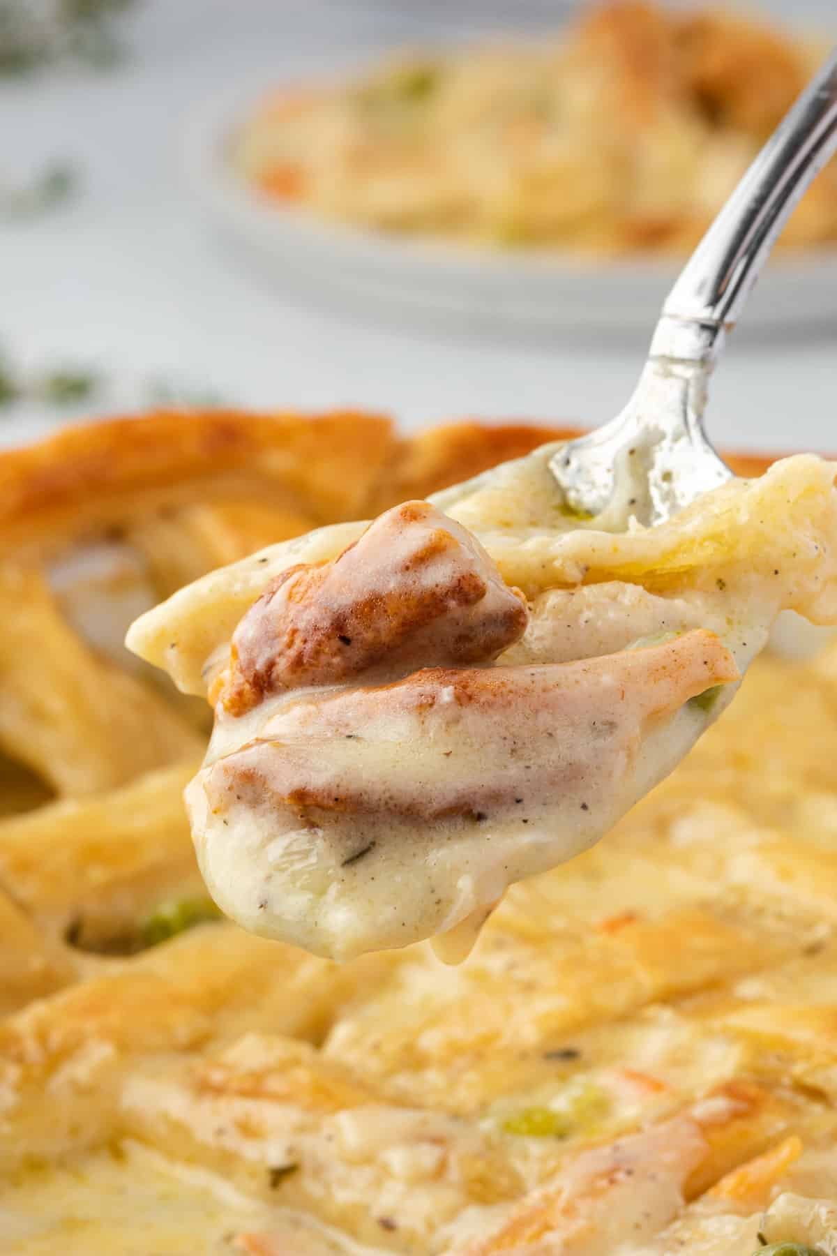 Close up of pot pie with puff pastry on a fork.