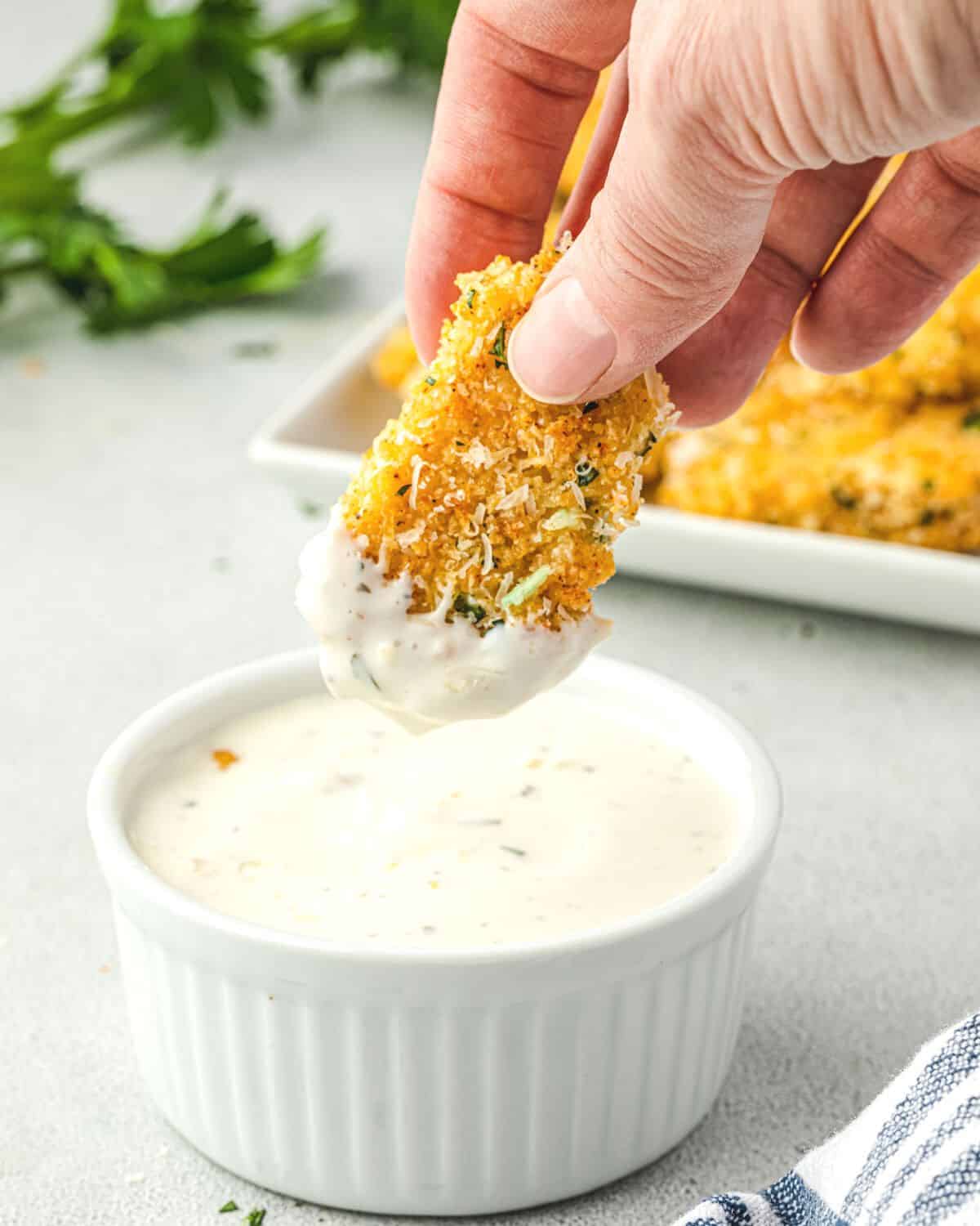 Dipping a crispy parmesan wing into Ranch dressing.