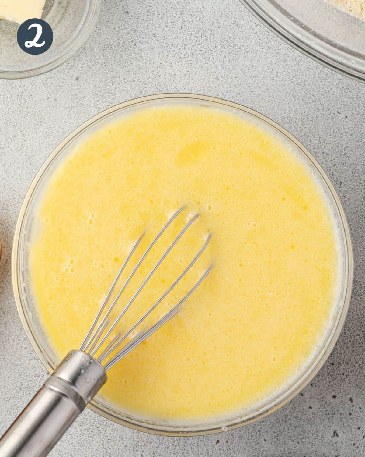 Whisking the butter, milk, and egg in a bowl.