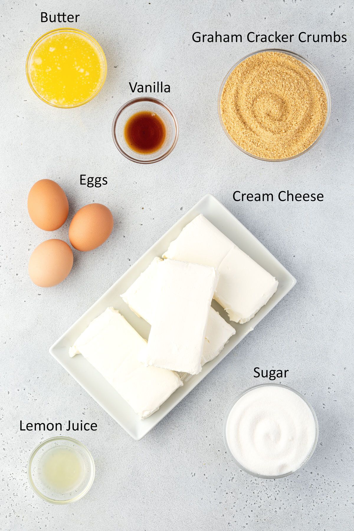 Overhead of labeled cheesecake ingredients.