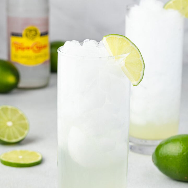 Two highball glasses of Texas Ranch water, with limes and a Topo Chico.