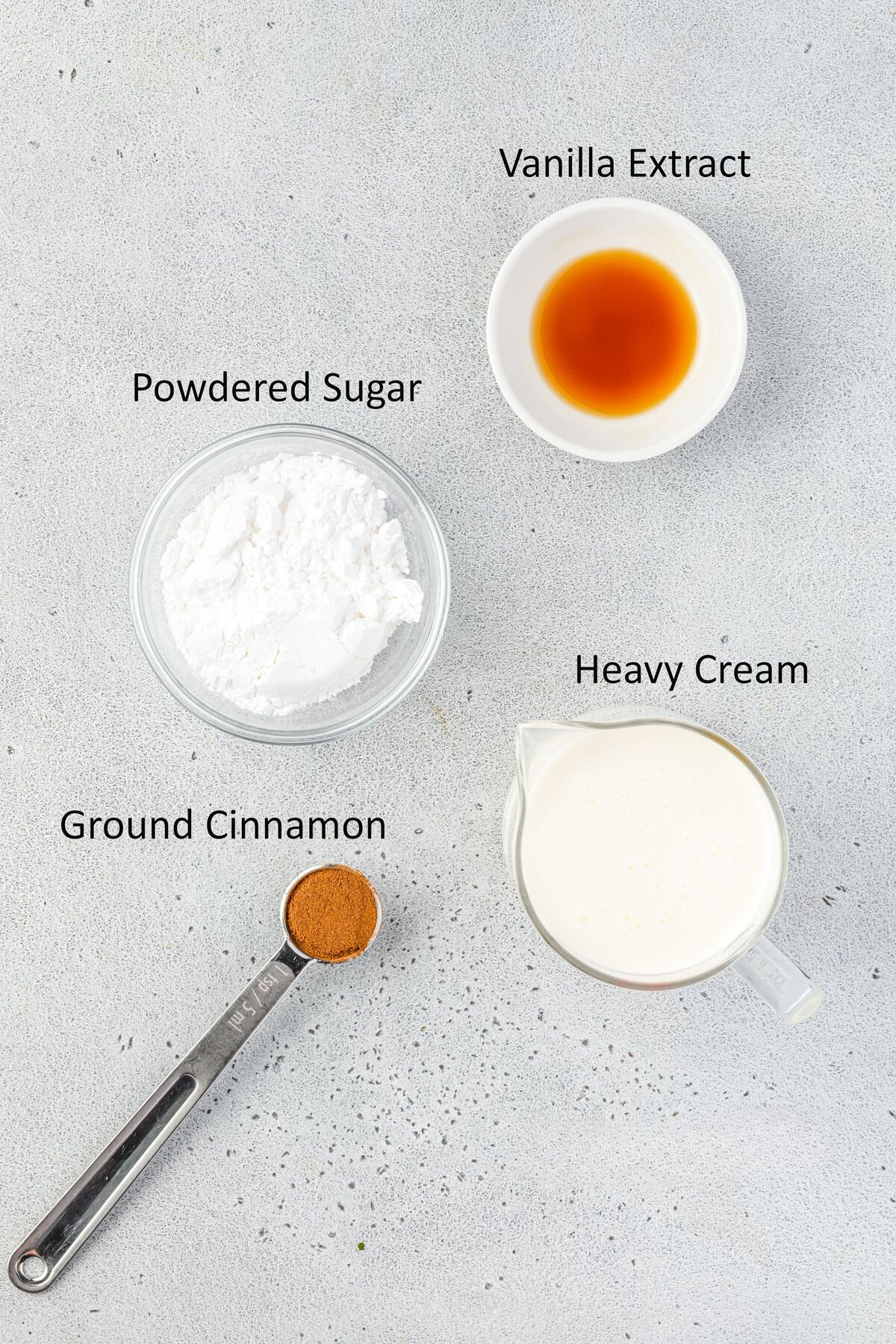 Ingredients for whipped cream in individual bowls.