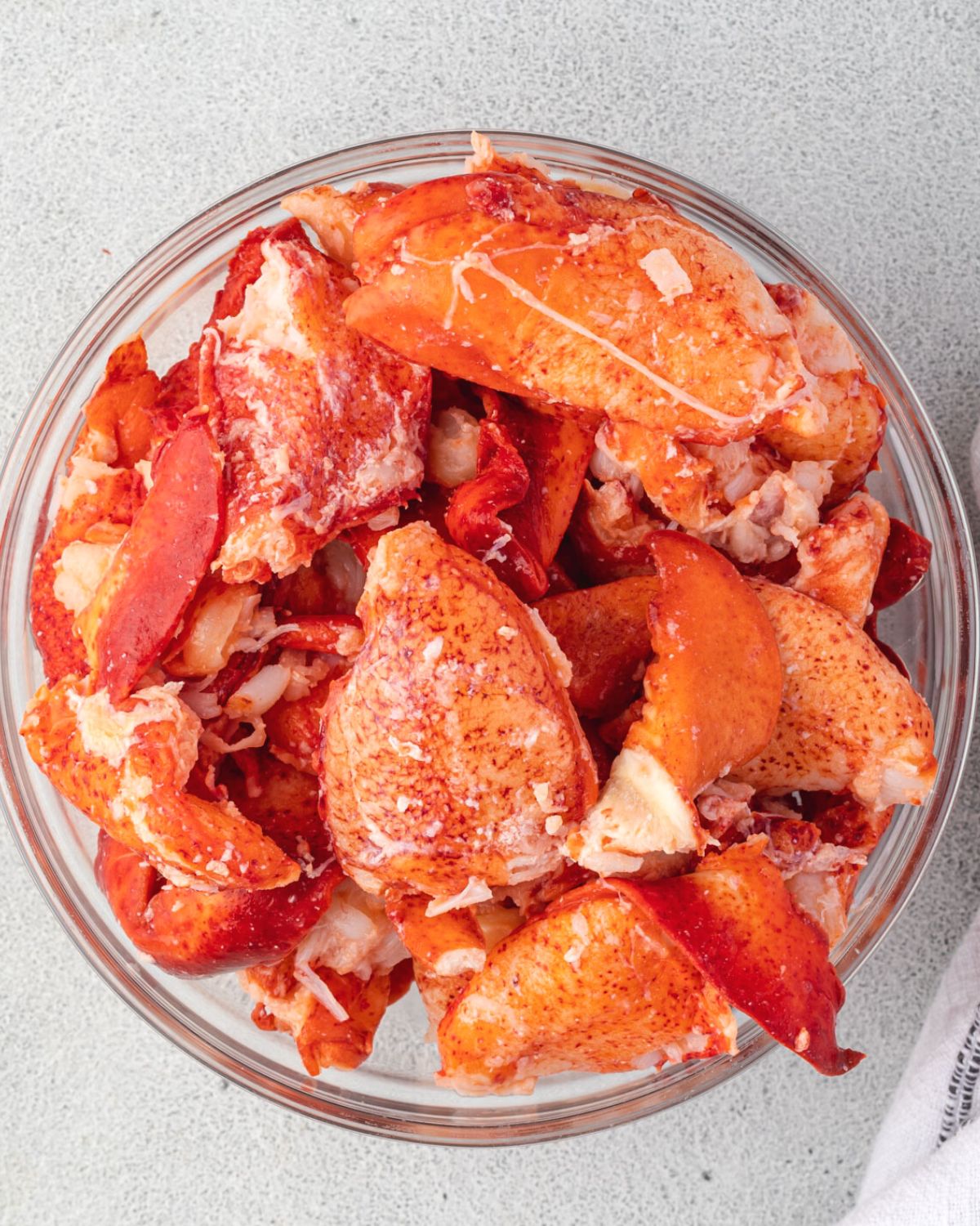 Bowl of bright orange lobster meat chunks.
