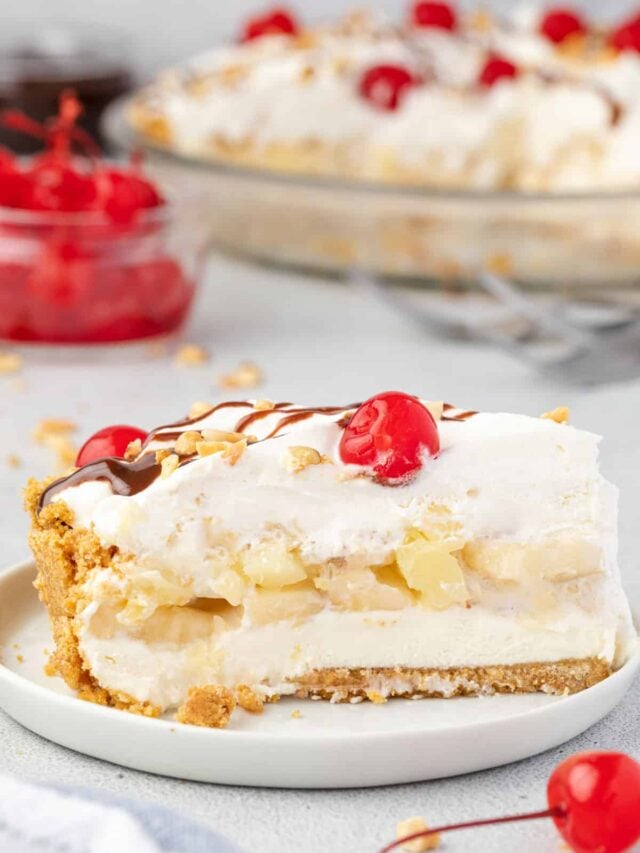 A slice of no-bake banana split pie shown from the side where you can see the layers.