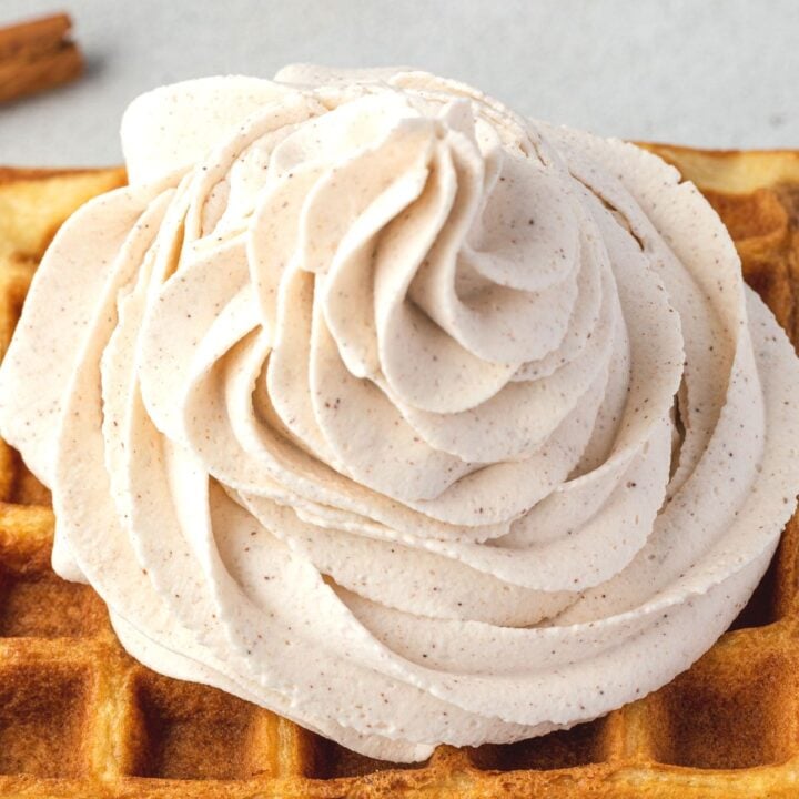 Close up of spiced whipped cream on a waffle.