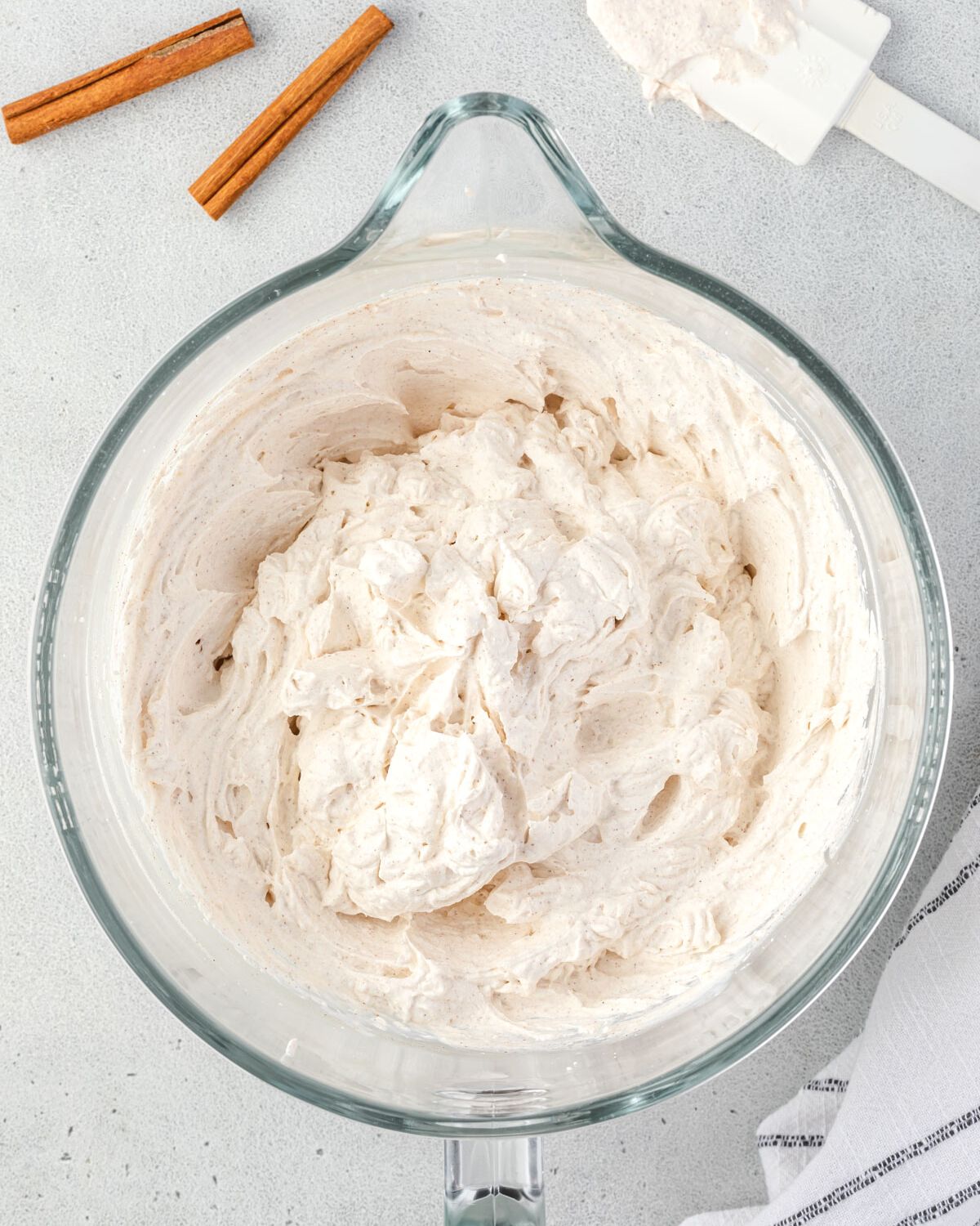 Cinnamon whipped cream beat to stiff peaks in large mixing bowl.