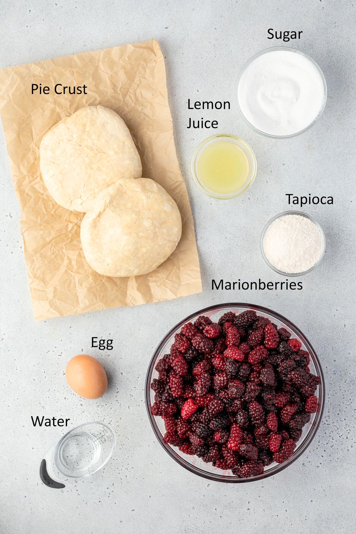 Ingredients for marionberry pie in individual bowls.