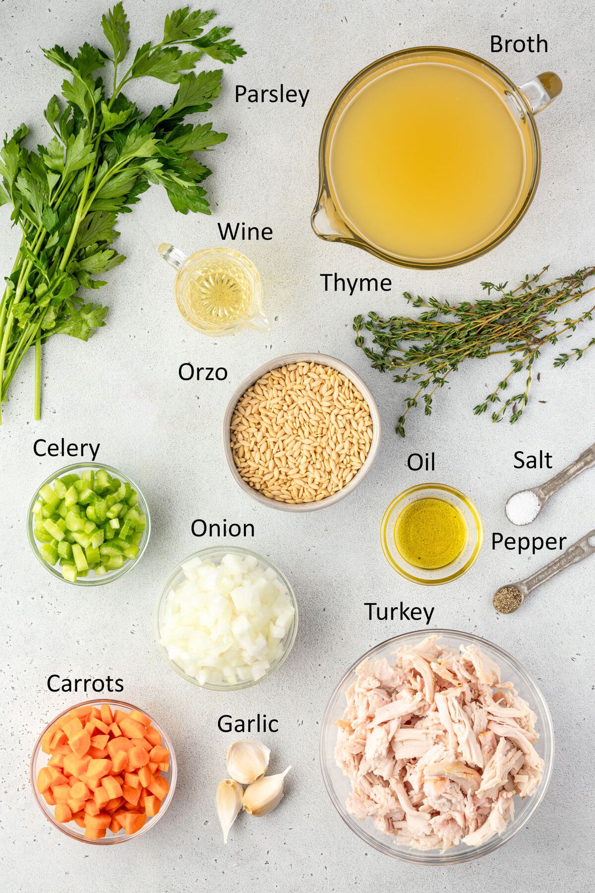 The ingredients for turkey orzo soup in individual bowls.