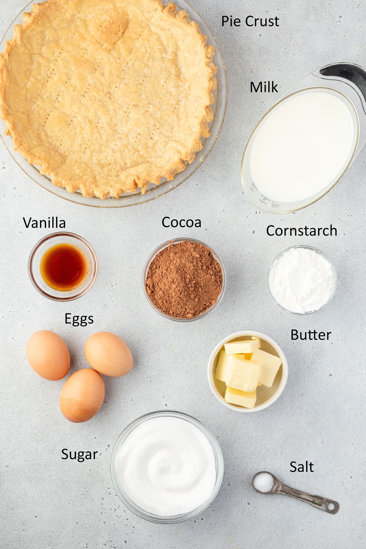 Old fashioned chocolate pie ingredients in individual bowls.