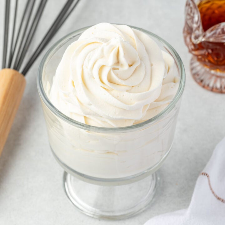 Maple whipped cream piped in a glass dish.
