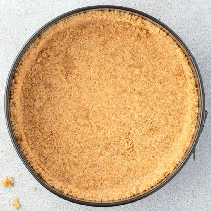 Vanilla wafer cheesecake crust in a springform pan.