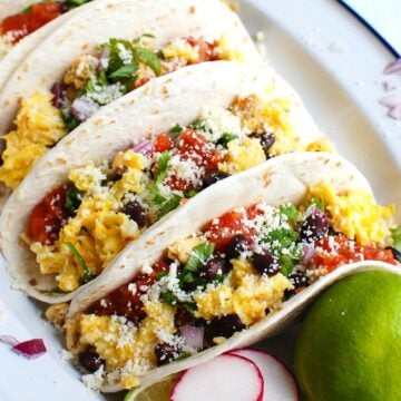 3 breakfast tacos on a plate.