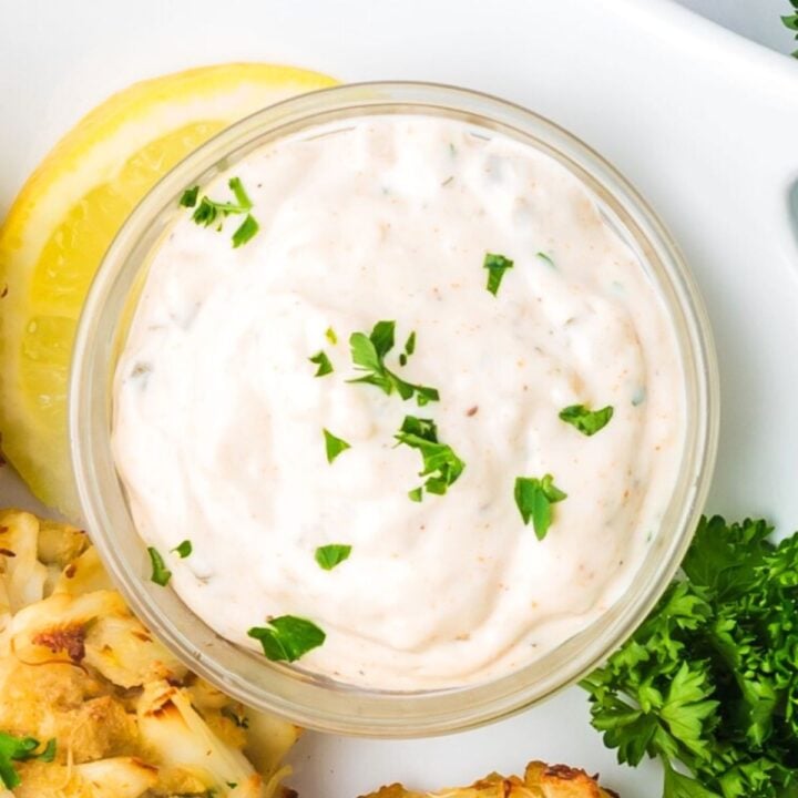 Bowl of remoulade sauce sprinkled with parsley.