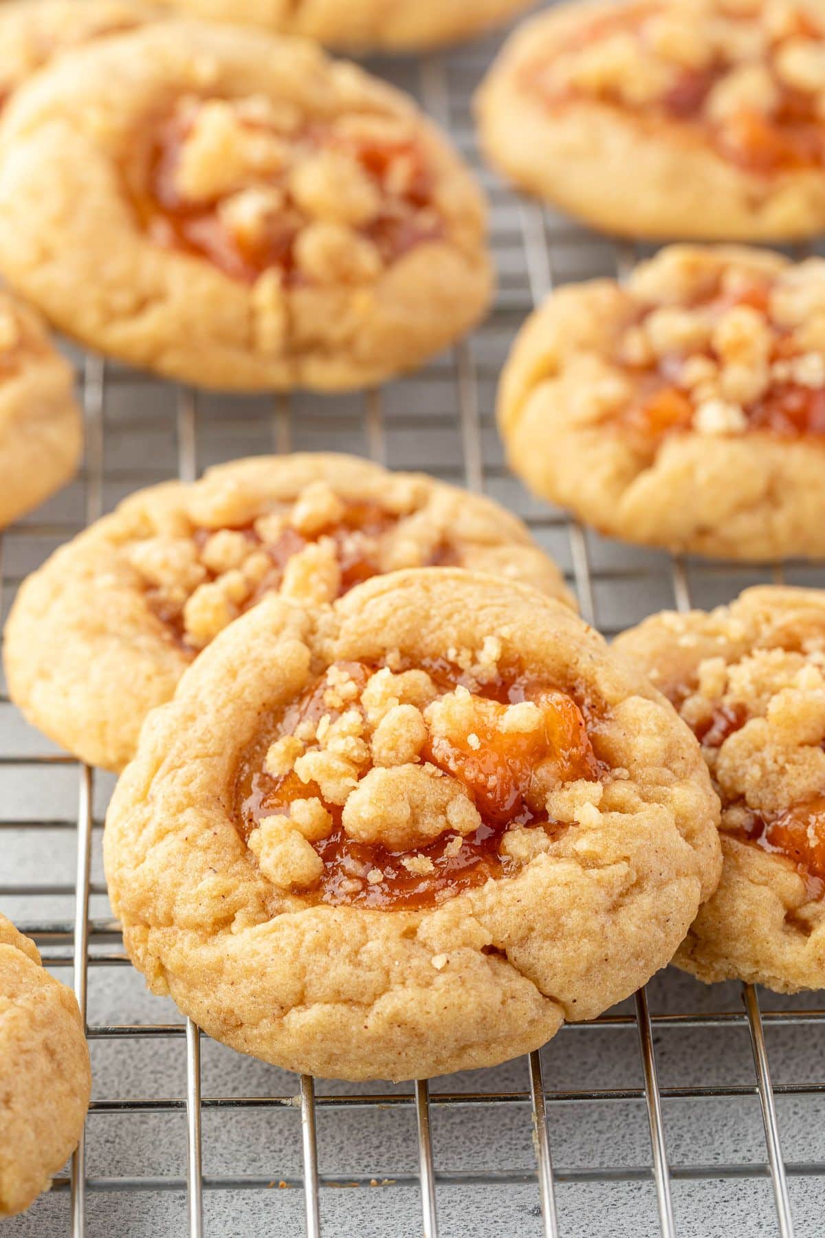 Peach cobbler cookies on a wire rack with a few of them overlapping.